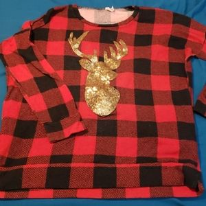 Buffalo plaid sweater with gold reindeer.